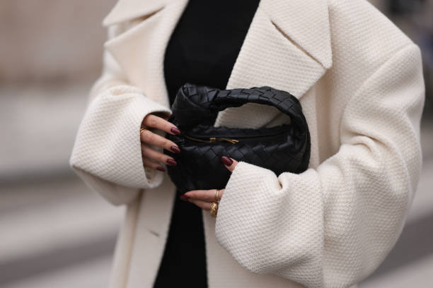 Thanya Wong seen wearing Polène Paris gold jewelry / rings, Vautrait cream white oversized wool short coat / jacket, COS black high neck top and...