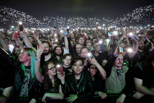The crowd light up their phones as they watch Swedish heavy metal band Sabaton perform on stage during 'The Tour To End All Tours' at Wembley Arena...
