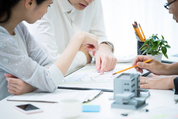 the customer and the employee are discussing the materials by looking at the materials. - home decoration stock pictures, royalty-free photos & images