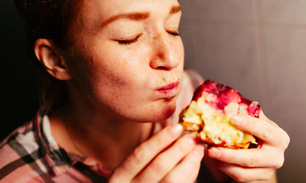 the female cake eater. - food stock pictures, royalty-free photos & images