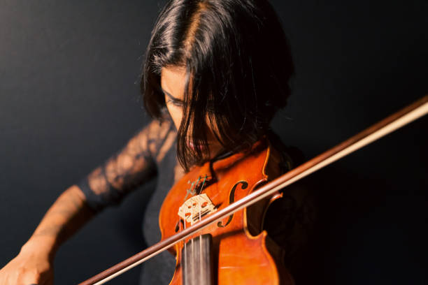 the female violinist. - concert stock pictures, royalty-free photos & images