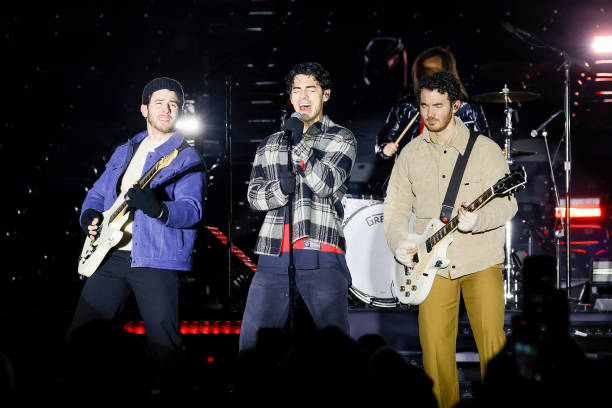 The Jonas Brothers perform during a pre-game concert prior to the 2024 Navy Federal Credit Union Stadium Series at MetLife Stadium on February 17,...