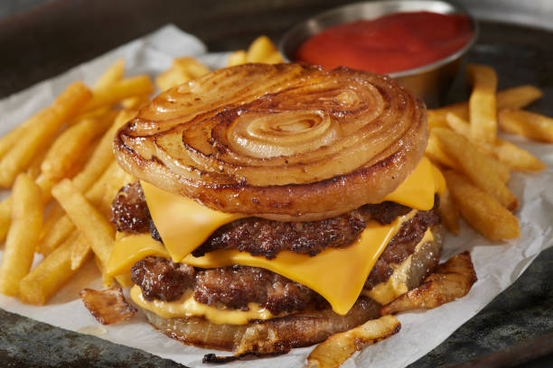 the viral fried onion wrapped double cheese burger - junk food stock pictures, royalty-free photos & images
