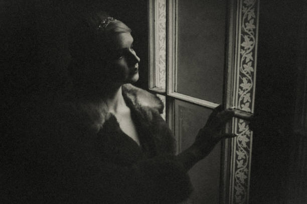 the woman at the window at night. - fashion stock pictures, royalty-free photos & images