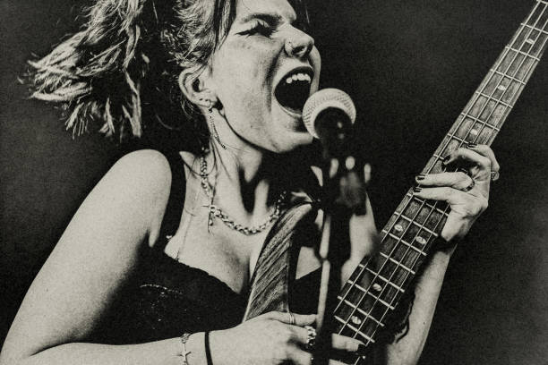 the young female rock musician. - concert stock pictures, royalty-free photos & images