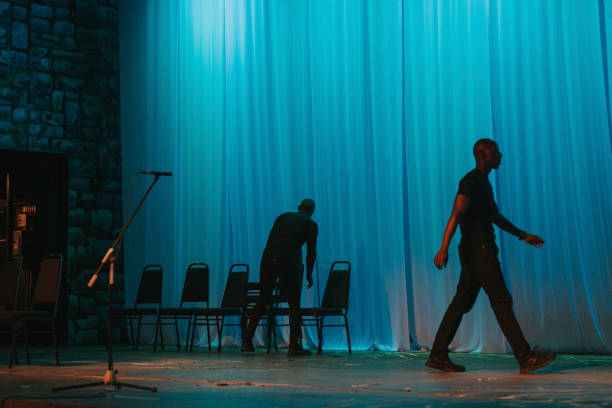 theatre crew arranging chairs on stage set getting ready for stage performance - concert stock pictures, royalty-free photos & images