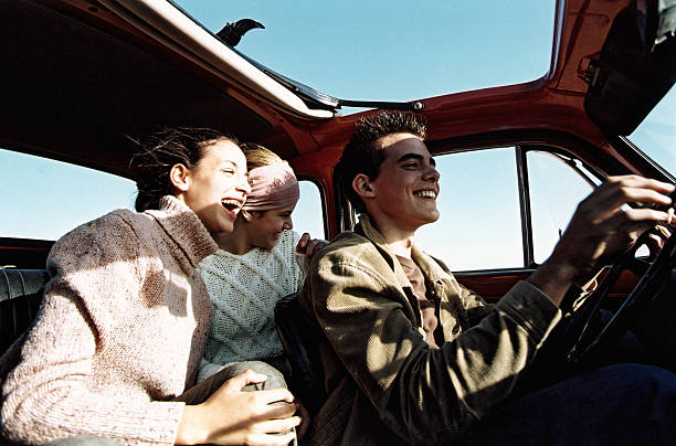 three teenagers (14-18) in car with open sunroof - travel stock pictures, royalty-free photos & images