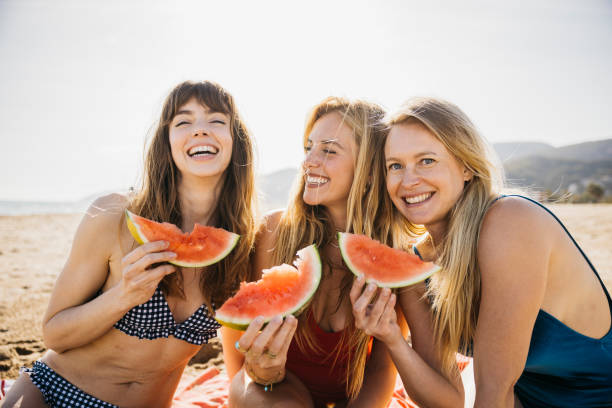 three women on the beach - food stock pictures, royalty-free photos & images