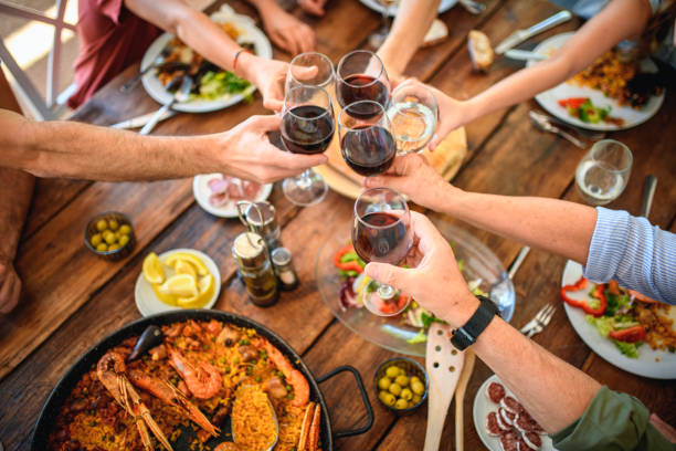 toasting with red wine and water before start of midday meal - food stock pictures, royalty-free photos & images