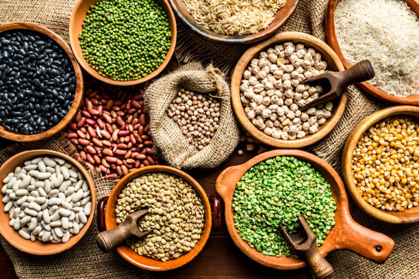 top view of leguminous seeds on rustic wood table - food stock pictures, royalty-free photos & images