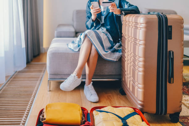 tourist in hotel room flight reservations - travel stock pictures, royalty-free photos & images
