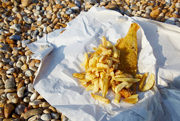 tradional fish n chips on the beach - junk food stock pictures, royalty-free photos & images