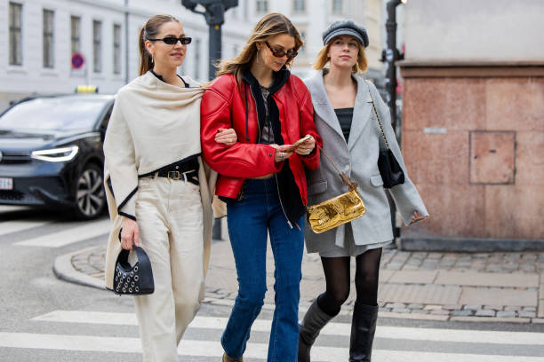 Trine Kjaer wears creme white top, pants, black bag & Anna Winck wears red leather jacket, denim jeans & Hanna Stefansson wears grey oversized...