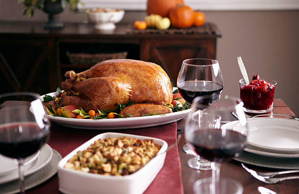 turkey, stuffing, and cranberry dishes on table. - food photos et images de collection