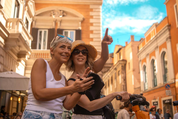 two beautiful mature female friends sightseeing in rome - travel stock pictures, royalty-free photos & images