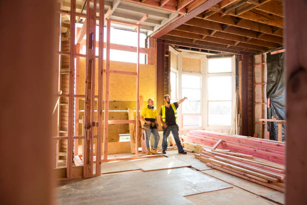 two construction workers talk together inside large house under renovation - home decoration stock pictures, royalty-free photos & images