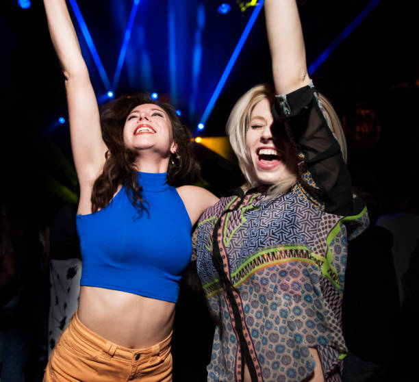 two friends having fun at music event - concert stock pictures, royalty-free photos & images