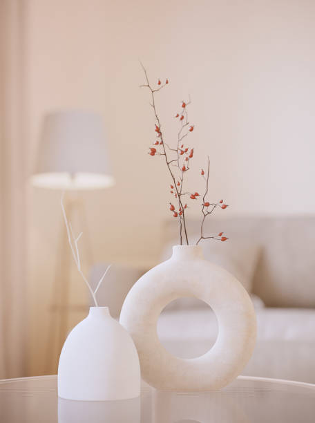 two modern white vases with brunches. white 3d rendering objects with blured interior background. minimalism japandi or scandinavian boho style - home decoration stock pictures, royalty-free photos & images