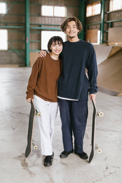 two skateboarders laughing - fashion stock pictures, royalty-free photos & images
