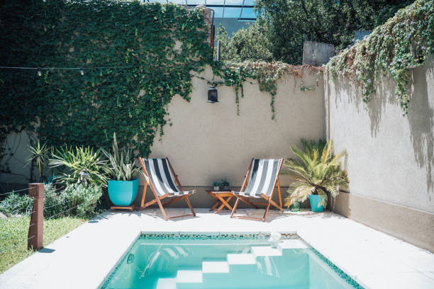 two sun chairs at swimming pool in patio - home decoration stock pictures, royalty-free photos & images