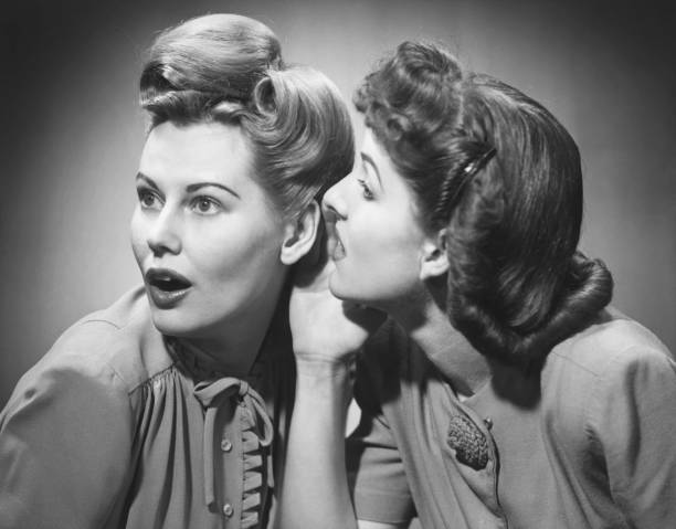 two women gossiping in studio (b&w) - hairstyle stock pictures, royalty-free photos & images