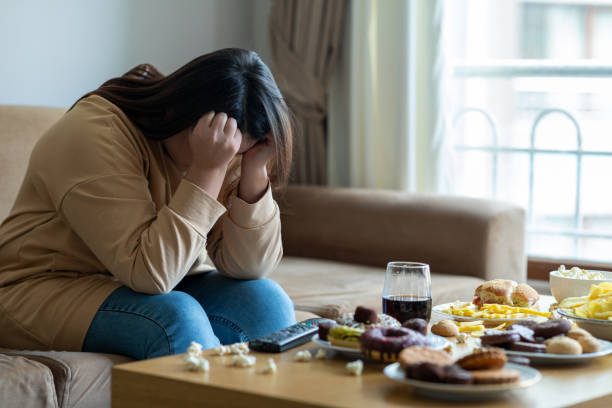 unhappy stressed woman - junk food stock pictures, royalty-free photos & images
