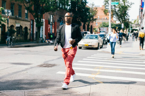 usa, nyc, brooklyn, man walking in the street, holding cup of coffee - fashion stock pictures, royalty-free photos & images