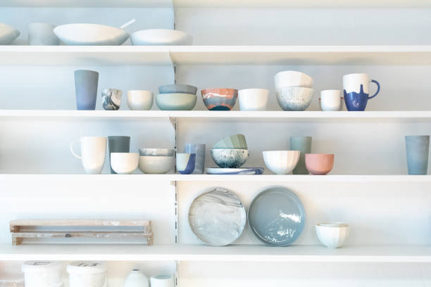 various earthenware on rack in pottery studio - home decoration stock pictures, royalty-free photos & images