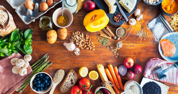 various types of food on wooden table - food stock pictures, royalty-free photos & images