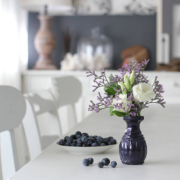 vase with flowers and bowl with blueberries - home decoration stock pictures, royalty-free photos & images