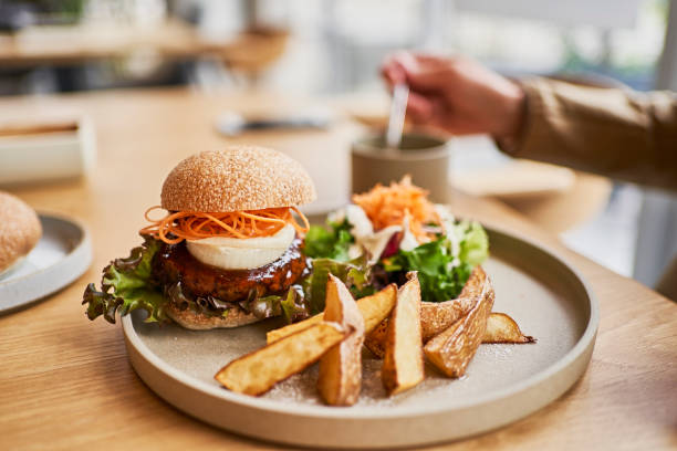vegan cafe's veggie burger lunch plate. - food stock pictures, royalty-free photos & images