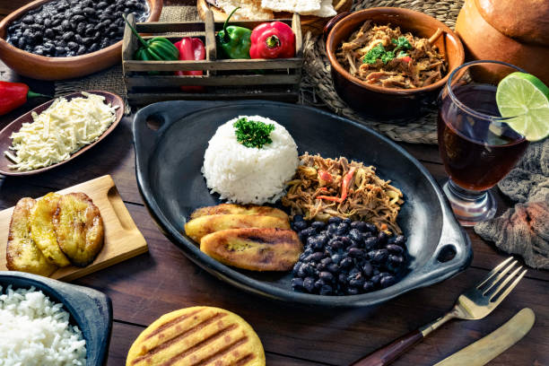 venezuelan traditional food, pabellon criollo with arepas, casabe and papelon with lemon drink - food stock pictures, royalty-free photos & images