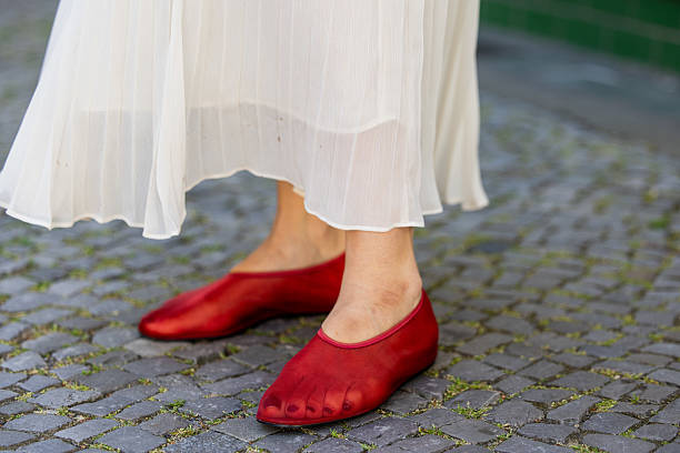 Victoria Scheu wears creme pleated maxi skirt H&M, red Mesh Ballerinas H&M during Berlin Fashion Week SS26 on June 30, 2025 in Berlin, Germany.
