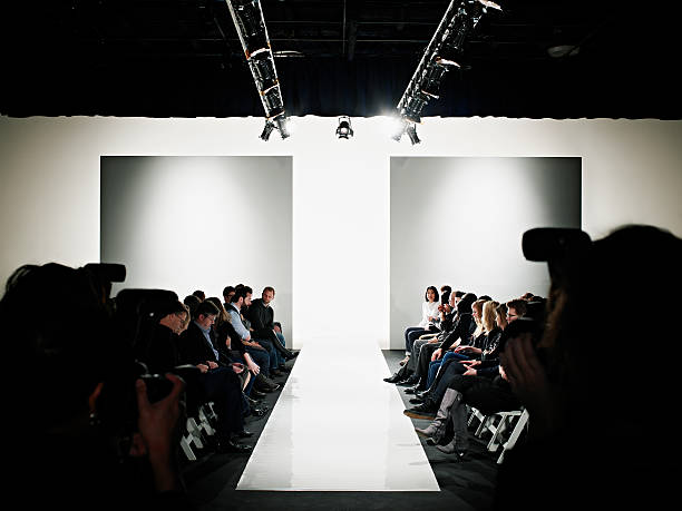 view down catwalk of photographers and crowd - fashion week stock pictures, royalty-free photos & images