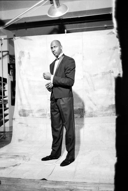 View of American basketball player Micheal Jordan as he poses, modeling samples from a line of formalwear, during a photo shoot, Chicago, Illinois,...