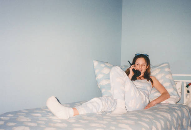 vintage teenage girl talking on telephone in 1990s bedroom cloud print y2k fashion 2000s - fashion stock pictures, royalty-free photos & images
