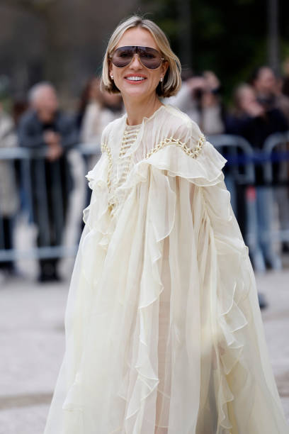 Violet Grace Atkinson wears butter yellow maxi ruffled dress, silver Chloe sunglasses, outside Zimmermann, during the Womenswear Fall/Winter...