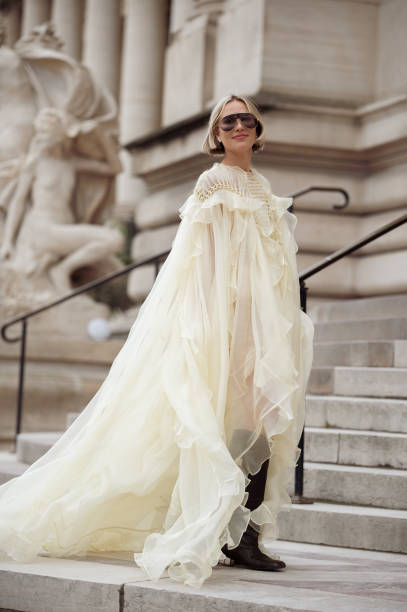Violet Grace wears pale yellow ruffled dress, boots, sunglasses outside the Zimmermann fashion show during the Womenswear Fall/Winter 2025/2026 as...