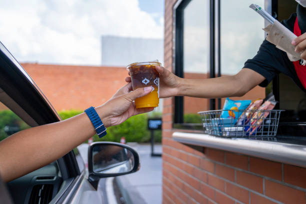 waiter deliver food throght drive thru service - junk food stock pictures, royalty-free photos & images