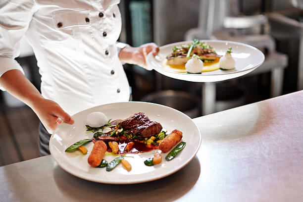 waiter picking up dishes in kitchen at restaurant - food stock pictures, royalty-free photos & images
