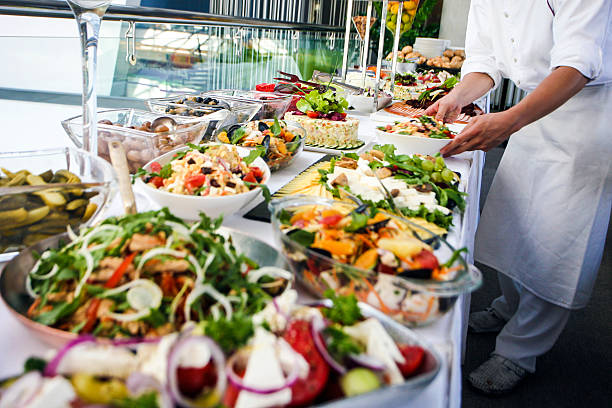 waiter serving a buffet table - food stock pictures, royalty-free photos & images