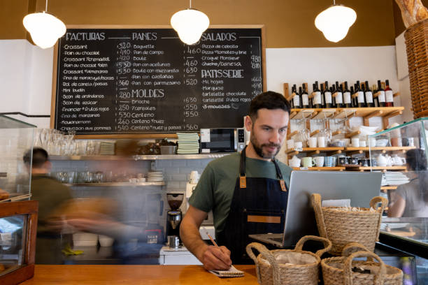 waiter working at a cafe and writing down an online order - junk food stock pictures, royalty-free photos & images