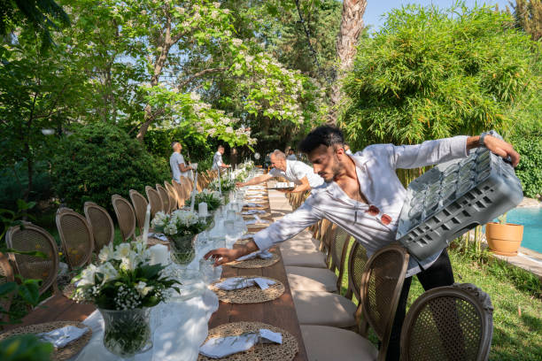 waiters setting banquet tables for wedding dinner in the backyard of the house - garden decoration stock pictures, royalty-free photos & images