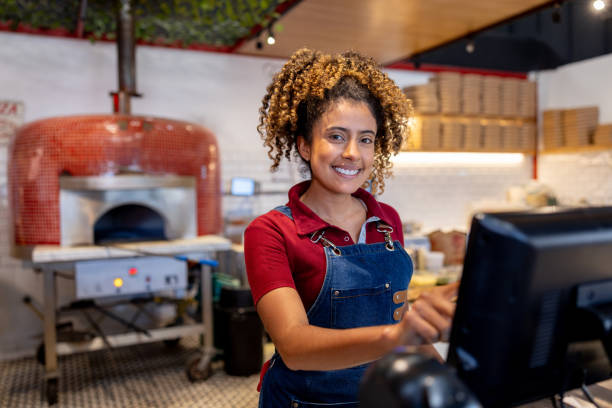 waitress working at a pizza place using the cash register - junk food stock pictures, royalty-free photos & images
