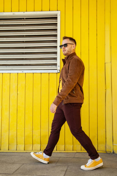 walking man in trendy outfit on street - fashion stock pictures, royalty-free photos & images