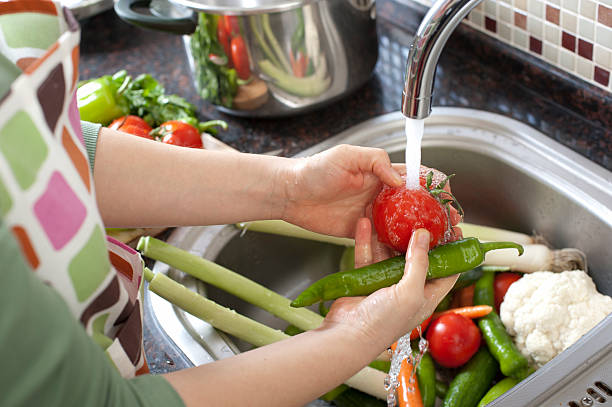 washing vegetables - food stock pictures, royalty-free photos & images