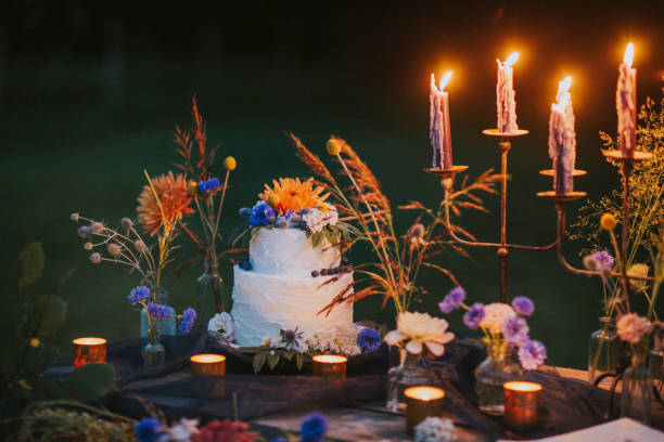 wedding cake on table with candles outdoors - garden decoration stock pictures, royalty-free photos & images