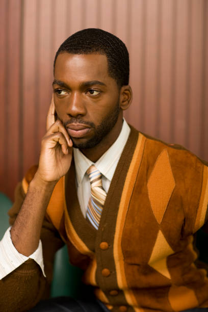 well-dressed african man looking pensive - fashion stock pictures, royalty-free photos & images