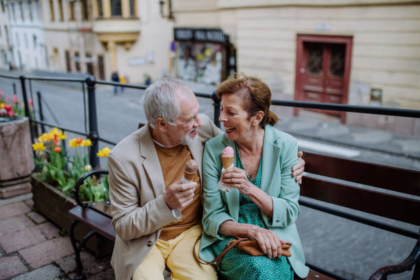 well dressed senior couple dating together in city centre, old town. - travel stock pictures, royalty-free photos & images