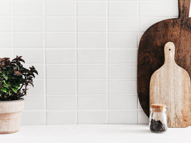 white kitchen background with kitchen utensils and green mint plant in pot - food stock pictures, royalty-free photos & images